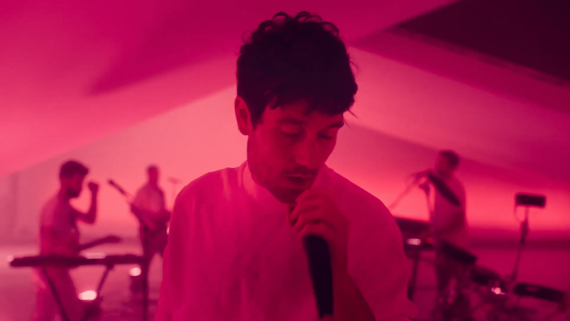 Bastille Music Video Singing in Bright Pink Lighting